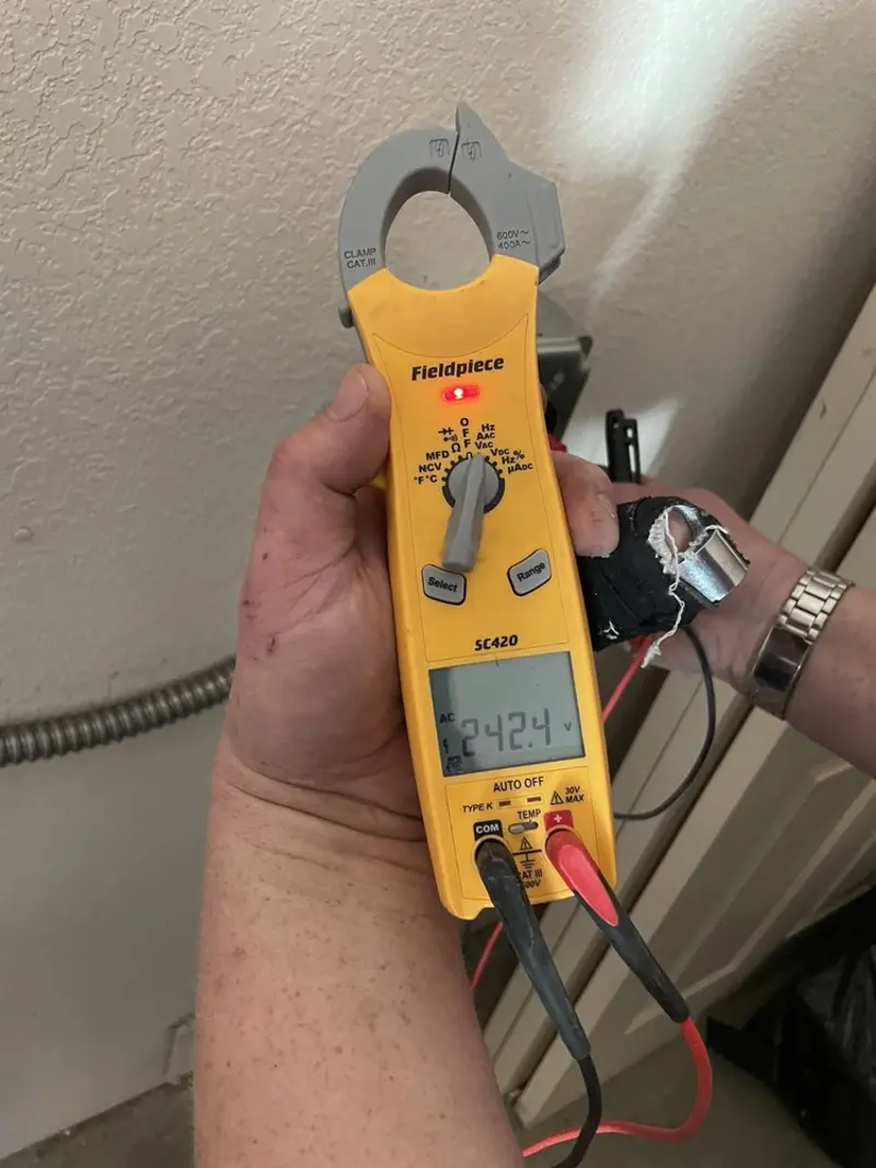 Voltage testing with clamp meter during Outlet Installation in Maple Grove